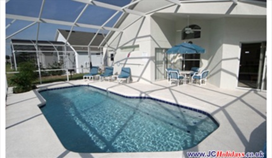 Large South facing pool deck with covered lanai and fan. JCHolidays in The Manors At Westridge, Davenport, Orlando