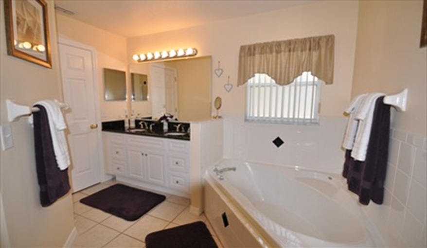 The large en-suite has separate corner bath & walk in shower.. Palm Tree Villa - Pool Lift, 5 STAR RATING in Doral Woods, Kissimmee, Orlando