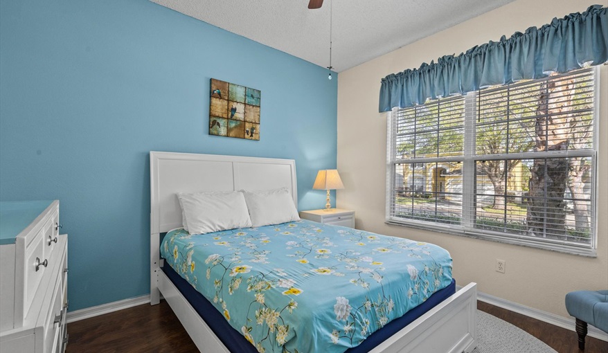 Peaceful queen bedroom with natural light, cozy bedding, and closet space — ideal for teens or grand. For the Best Disney Vacation-Tropical Paradise Villa in Emerald Island Resort, Kissimmee, Orlando