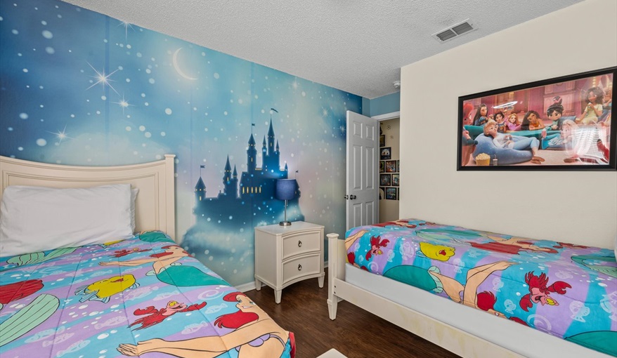 Disney Princess-themed twin bedroom with two beds and whimsical décor — a magical space for little r. For the Best Disney Vacation-Tropical Paradise Villa in Emerald Island Resort, Kissimmee, Orlando