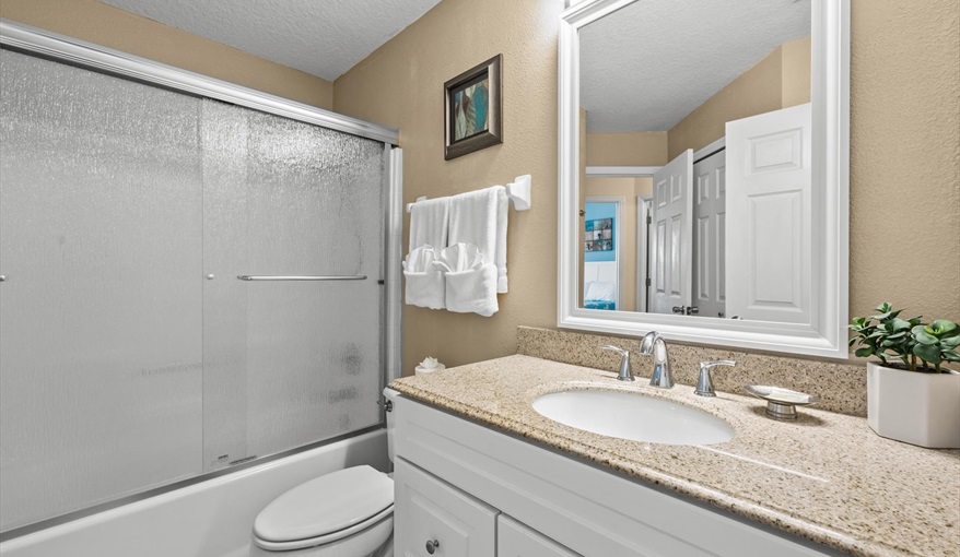 Full family bath with granite countertop, shower/tub combo, and plenty of storage space.. For the Best Disney Vacation-Tropical Paradise Villa in Emerald Island Resort, Kissimmee, Orlando