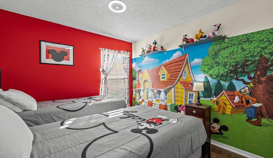 Mickey-themed twin bedroom with two beds and playful décor — fun and comfortable for young Disney fa. For the Best Disney Vacation-Tropical Paradise Villa in Emerald Island Resort, Kissimmee, Orlando