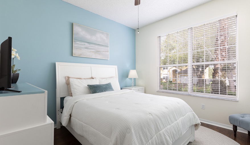 Peaceful queen bedroom with soft tones and natural light for restful nights.. For the Best Disney Vacation-Tropical Paradise Villa in Emerald Island Resort, Kissimmee, Orlando