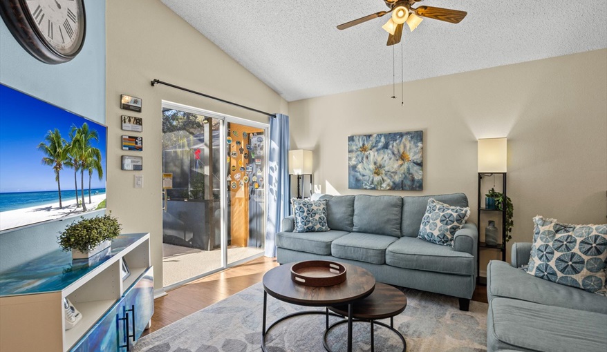 Bright living space with sliding doors leading directly to the screened-in pool area.. For the Best Disney Vacation-Tropical Paradise Villa in Emerald Island Resort, Kissimmee, Orlando