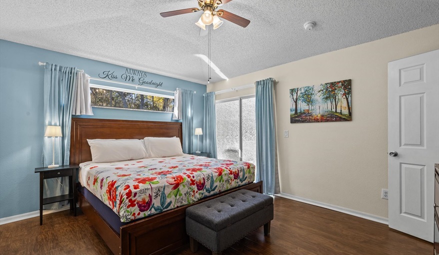 Spacious king master suite with private pool access, TV, walk-in closet, and en-suite bathroom.. For the Best Disney Vacation-Tropical Paradise Villa in Emerald Island Resort, Kissimmee, Orlando