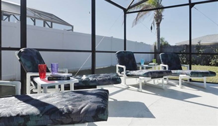 Covered pool with loungers . . .. KissimmeeDisneyVilla in Indian Point, Kissimmee, Orlando
