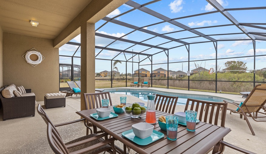 Al fresco dining. Goofys Golf Getaway - Luxury Executive Disney Villa on Golf Course Gated Community, South Facing Pool,  No Rear Neighbours and Conservation Views in Providence, Davenport, Orlando