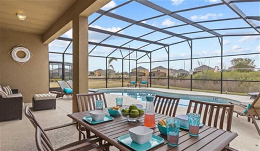 Al fresco dining. Goofys Golf Getaway - Luxury Executive Disney Villa on Golf Course Gated Community, South Facing Pool,  No Rear Neighbours and Conservation Views in Providence, Davenport, Orlando