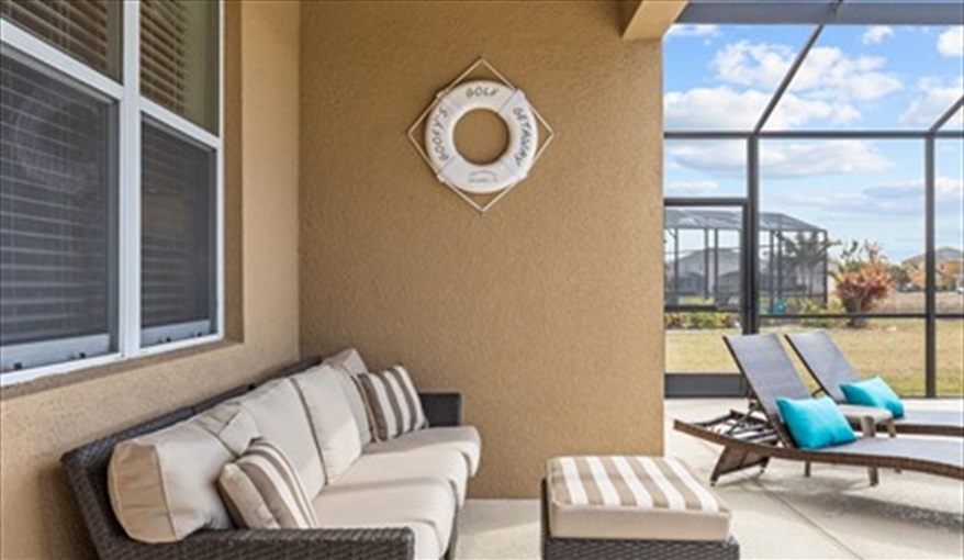 Covered lanai with comfortable seating. Goofys Golf Getaway - Luxury Executive Disney Villa on Golf Course Gated Community, South Facing Pool,  No Rear Neighbours and Conservation Views in Providence, Davenport, Orlando