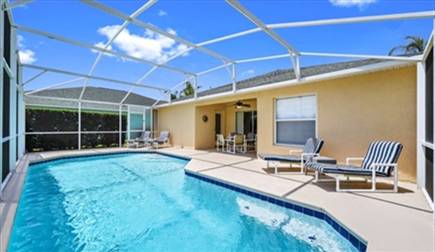 Private pool deck area with loungers and covered outside dining. Three Palms Villa in Town Centre Reserve, Davenport, Orlando
