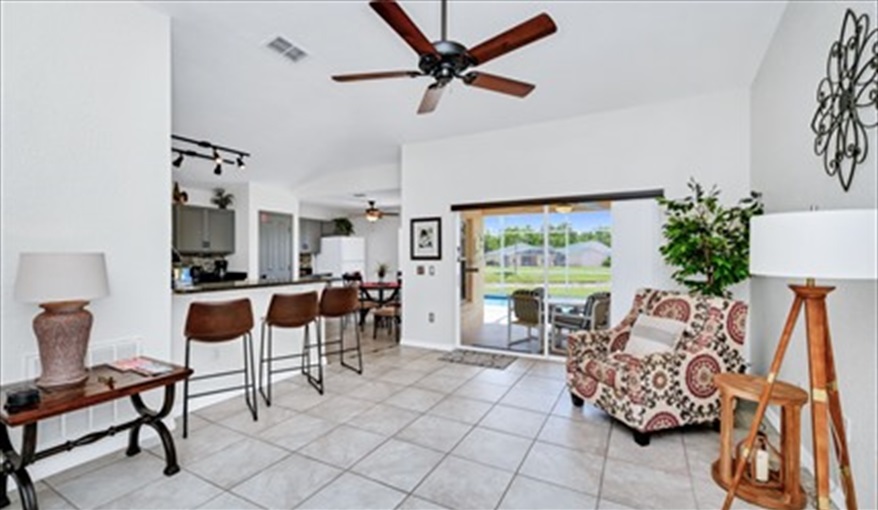 Living area / kitchen diner leading to pool deck . Three Palms Villa in Town Centre Reserve, Davenport, Orlando