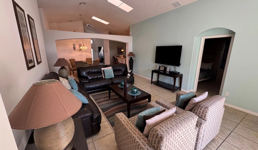 Gather the family in this stunning living space flooded with natural light from cathedral ceiling. Daisy's Den  in Indian Ridge, Kissimmee, Orlando