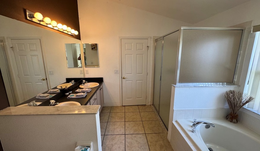 Indulge in the spa-like master ensuite with luxurious soaking tub for relaxation. Daisy's Den  in Indian Ridge, Kissimmee, Orlando