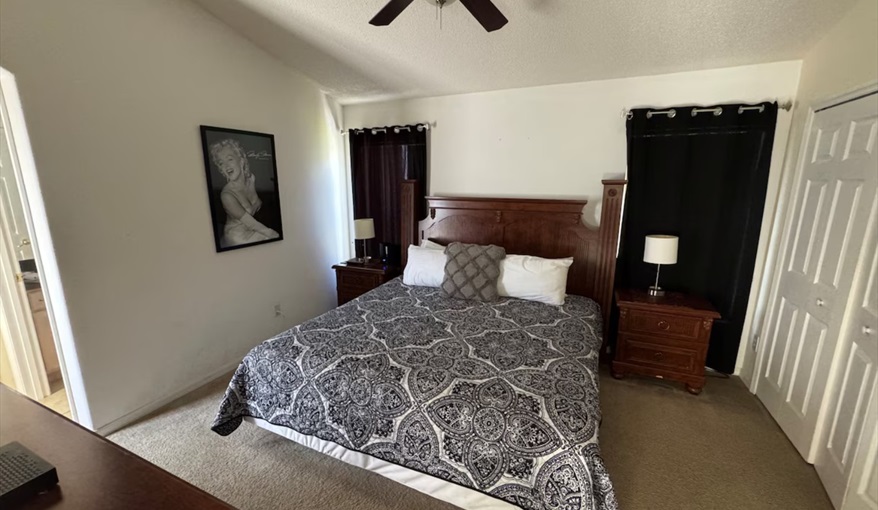 The comfortable guest bedroom features quality dark wood furnishings. Daisy's Den  in Indian Ridge, Kissimmee, Orlando
