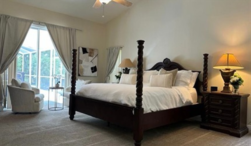 Large master bedroom with access to the pool, walk in wardrobe and bathroom . Doral Woods Secluded Florida Villa Updated June 2023 in Doral Woods, Kissimmee, Orlando