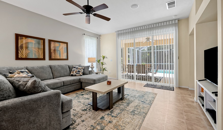 Living room with pool deck views. CJS FLORIDA VILLA in Esprit, Davenport, Orlando