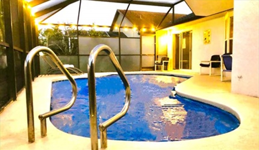 Outside lighting highlighting the private pool. Ref 993PF. Family home, free BBQ. Near Disney. Pet friendly in Lindfields, Kissimmee, Orlando