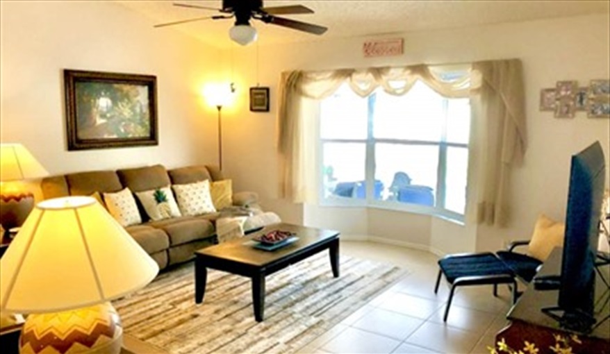 A view of the pool and deck space from the living area. Ref 993PF. Family home, free BBQ. Near Disney. Pet friendly in Lindfields, Kissimmee, Orlando