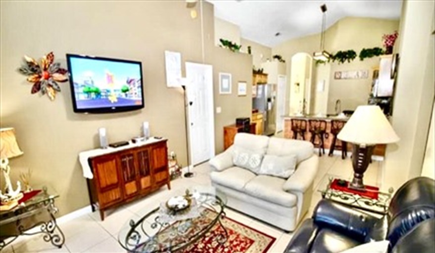 Main seating area with large TV and plenty of seating. Ref 17. Lake Berkley. Superb Villa , own pool. BBQ. Nr Disney. Gated resort in Lake Berkley Resort, Kissimmee, Orlando