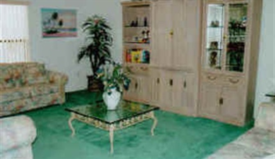 The lounge area with two three seater settees and one two seater settee. The Palms in Sunridge Woods, Davenport, Orlando