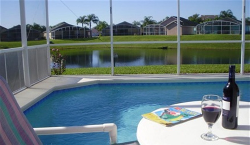 Relax by the pool overlooking the pond. FAMILY-FRIENDLY 4-BED VILLA in very popular, beautiful, quiet, gated resort community!! GREAT LOCATION, close to DISNEY!!   in Reserve at Town Center, Davenport, Orlando