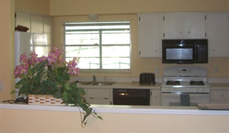view of the kitchen from living room. Luxury villa, 3 Bedrooms, 2 Baths with stunning pool and games room in Indian Ridge, Kissimmee, Orlando