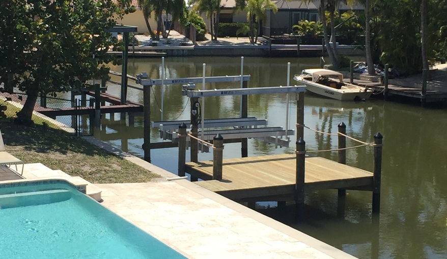 Aerial view of pool, lower deck, dock and corner of canal. Island Villa with 33 Foot Infinity Pool, Dock, Dolphin Visits in Fort Myers Beach, Fort Myers, Gulf Coast