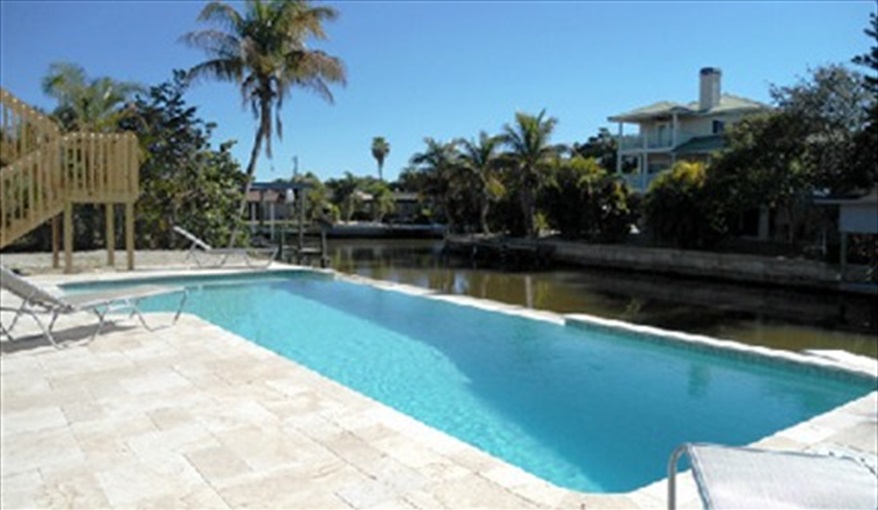 Large south-facing pool deck area. Proper pool loungers provided.. Island Villa with 33 Foot Infinity Pool, Dock, Dolphin Visits in Fort Myers Beach, Fort Myers, Gulf Coast