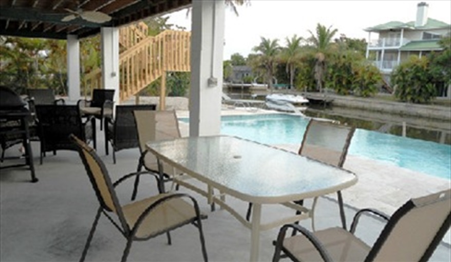 Outside living Florida style.. Island Villa with 33 Foot Infinity Pool, Dock, Dolphin Visits in Fort Myers Beach, Fort Myers, Gulf Coast