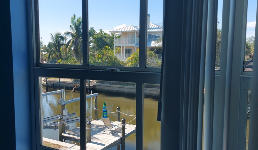 View from Master Bedroom over pool, deck, dock and canal.. Island Villa with 33 Foot Infinity Pool, Dock, Dolphin Visits in Fort Myers Beach, Fort Myers, Gulf Coast