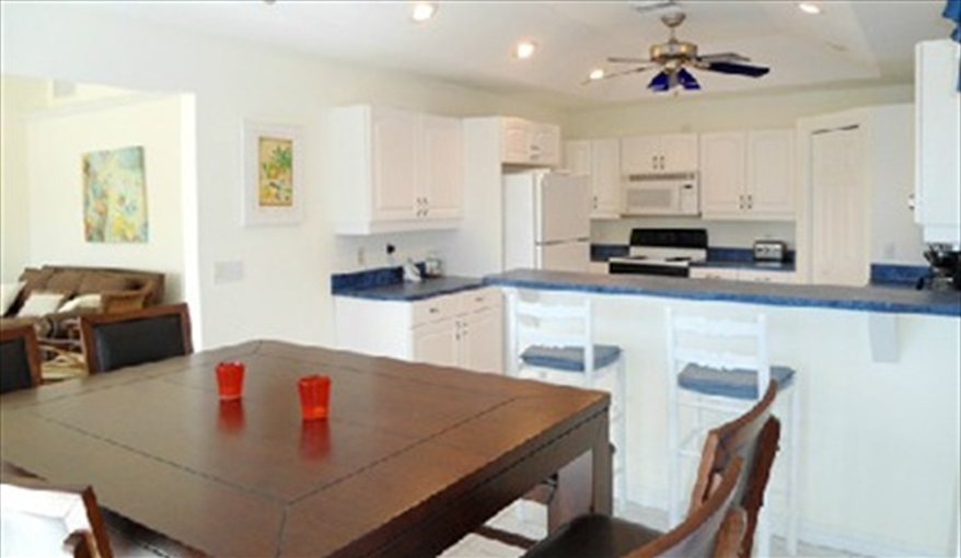 Open plan dining, breakfast bar and kitchen area.. Island Villa with 33 Foot Infinity Pool, Dock, Dolphin Visits in Fort Myers Beach, Fort Myers, Gulf Coast