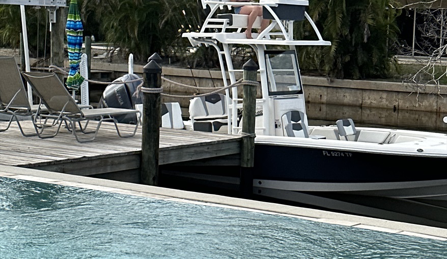 Guest boat tied up to the dock, free mooring for the duration!. Island Villa with 33 Foot Infinity Pool, Dock, Dolphin Visits in Fort Myers Beach, Fort Myers, Gulf Coast