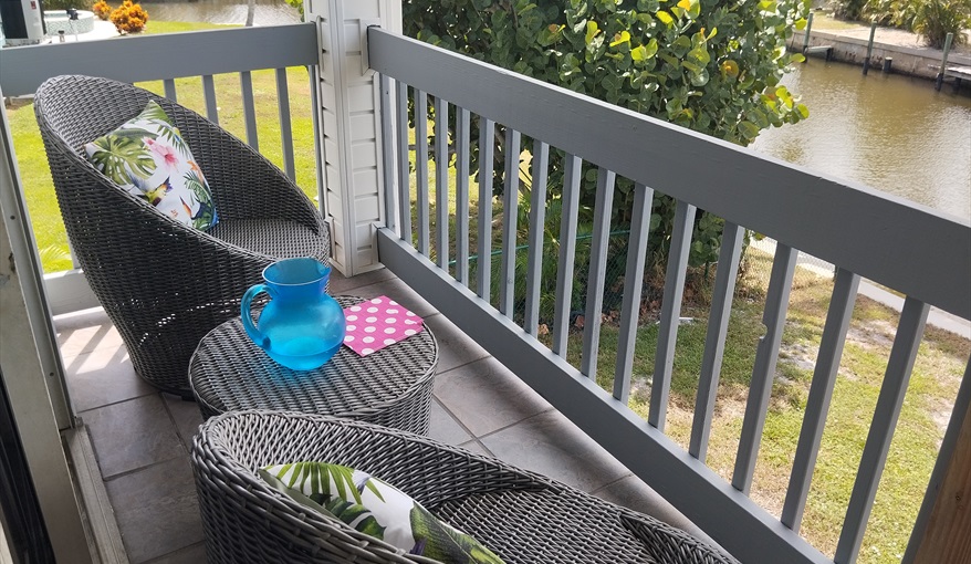 Small raised rear balcony / porch for breakfast, coffee or the sunsets. Island Villa with 33 Foot Infinity Pool, Dock, Dolphin Visits in Fort Myers Beach, Fort Myers, Gulf Coast