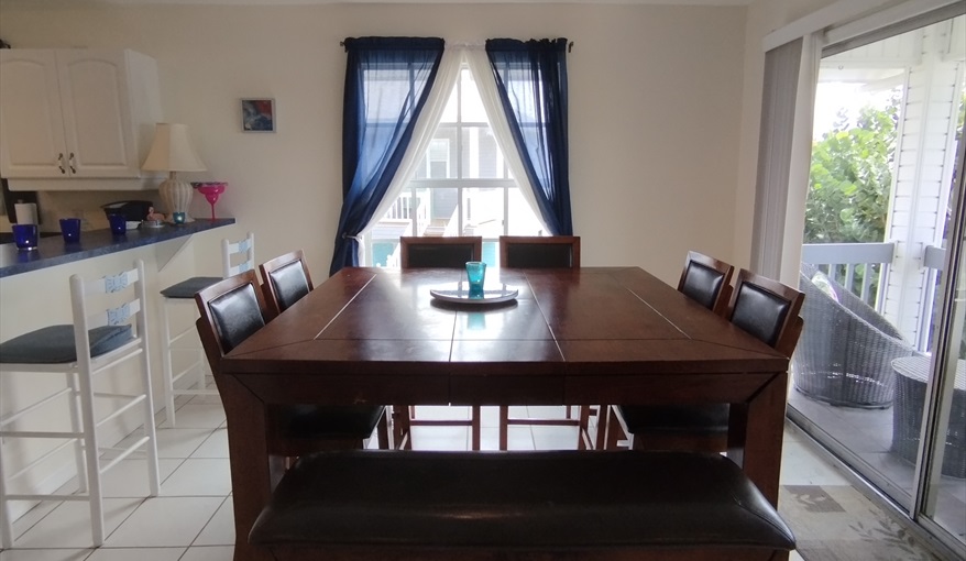 Breakfast Bar, Dining Table and Rear Balcony / Porch. Island Villa with 33 Foot Infinity Pool, Dock, Dolphin Visits in Fort Myers Beach, Fort Myers, Gulf Coast