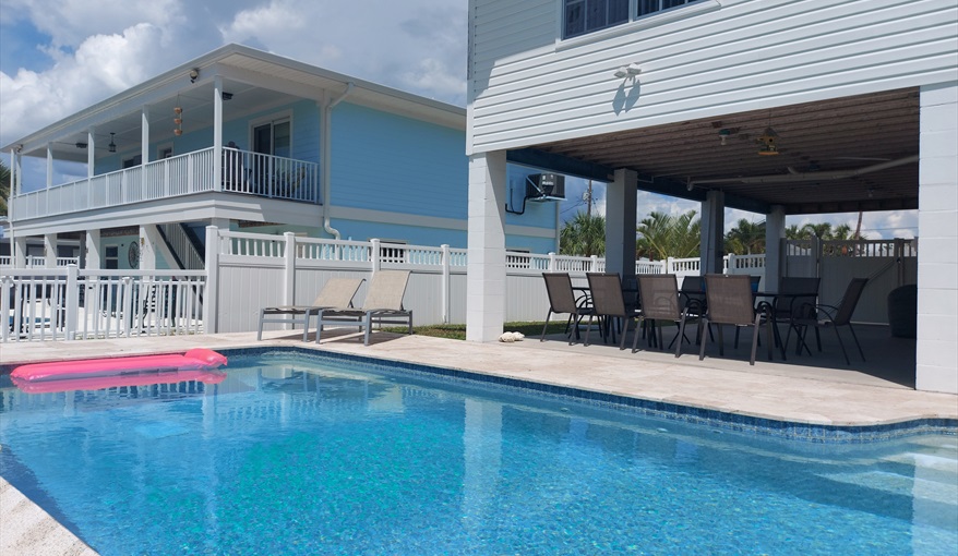 Outside dining in front of pool.. Island Villa with 33 Foot Infinity Pool, Dock, Dolphin Visits in Fort Myers Beach, Fort Myers, Gulf Coast