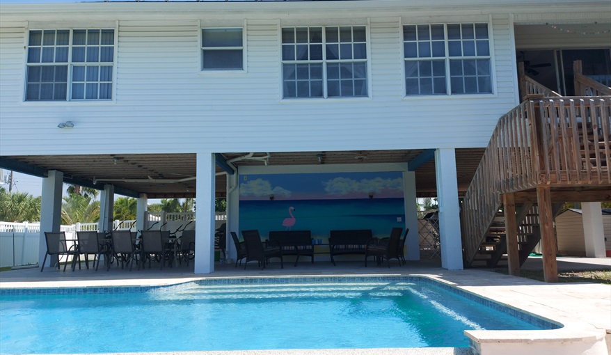 Outside living Florida style, shaded upper pool deck dining and sitting areas.. Island Villa with 33 Foot Infinity Pool, Dock, Dolphin Visits in Fort Myers Beach, Fort Myers, Gulf Coast